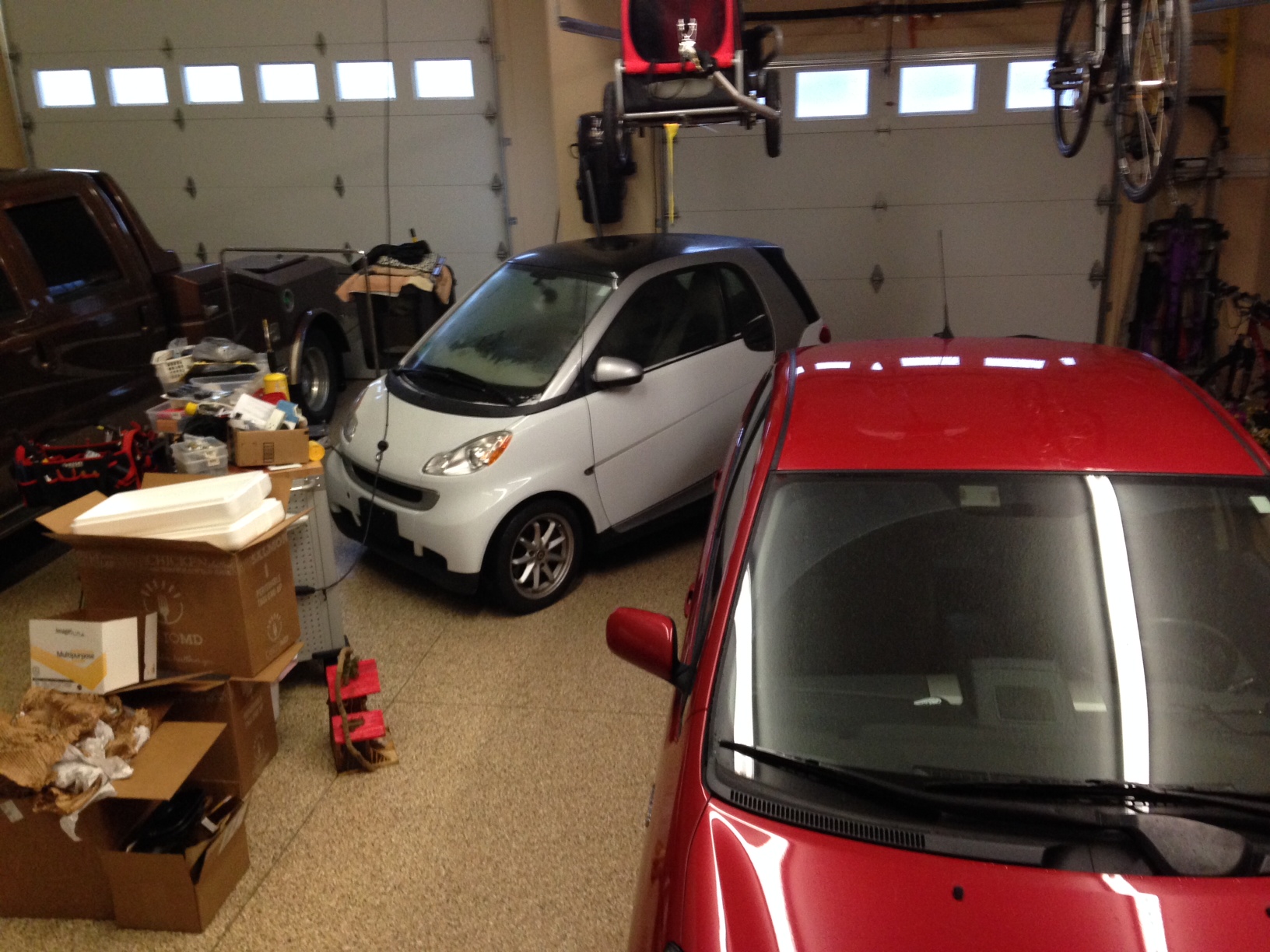 Dave and Amy's white Smart Car tucked into our garage.